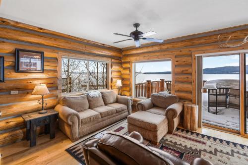 a living room with a couch and chairs in a log cabin at King's Cabin in West Yellowstone