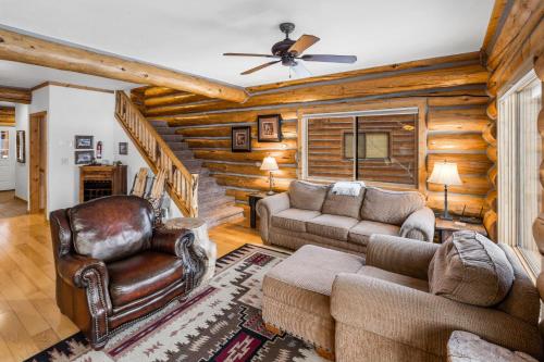 a living room with a couch and a chair at King's Cabin in West Yellowstone
