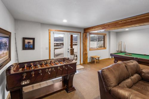 a living room with a pool table at King's Cabin in West Yellowstone