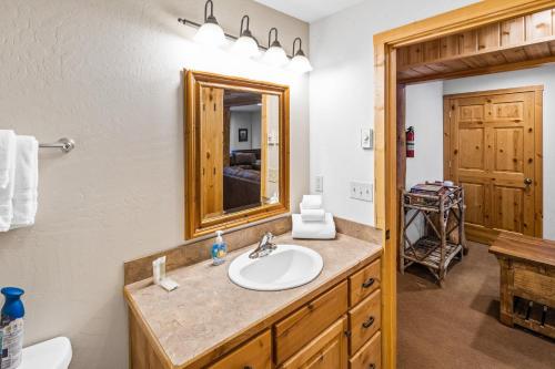 a bathroom with a sink and a mirror at King's Cabin in West Yellowstone