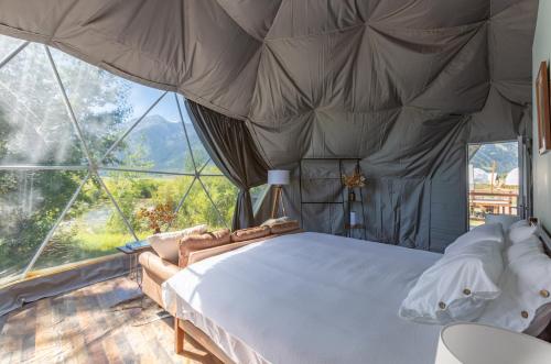 a bedroom with a bed and a large window at Tammah Jackson Hole in Wilson
