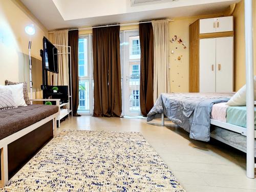 a bedroom with a bed and a rug at 7 pax Maximum Capacity at Cozy Cove Spacious Studio with Balcony at The Venice Grand Canal Mall PARKING ON PREMISE with Pool in Manila