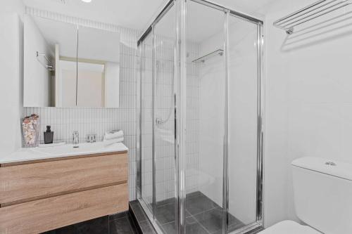 a bathroom with a shower and a sink at Seascape - Hosted by Burleigh Letting in Gold Coast