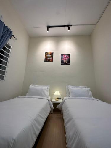 two beds sitting next to each other in a room at 22A HOSTEL in George Town