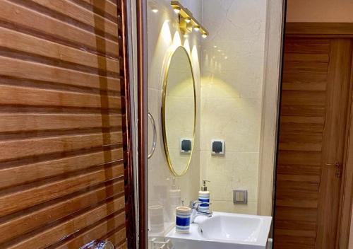 a bathroom with a sink and a mirror at CHIC & COSY appartement trés calme in Agadir