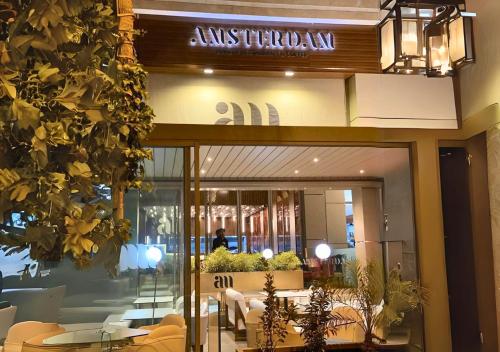 a restaurant with tables and chairs in front of a building at CHIC & COSY appartement trés calme in Agadir