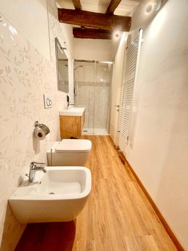a bathroom with a sink and a toilet at Domus 44 Rooms - Porta Nuova in Verona