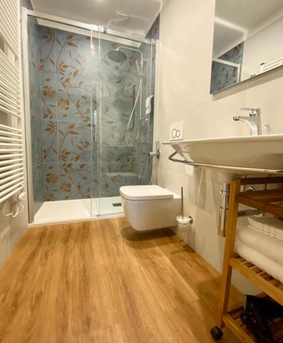 a bathroom with a shower and a toilet and a sink at Domus 44 Rooms - Porta Nuova in Verona