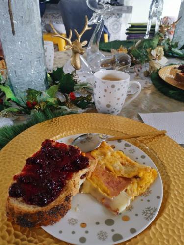 a plate of food with a piece of cake and a cup of coffee at Betania Alojamiento Rural Quindío Eje Cafetero espectacular! in Circasia