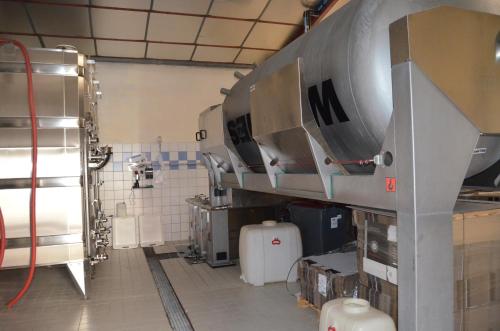 a kitchen with a large machine in a room at Chambres D'hotes & Champagne Douard in La Chapelle-Monthodon
