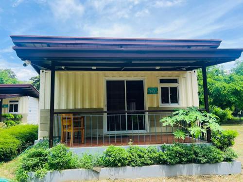 a small yellow house with a blue roof at Samba Bluewater Resort in Olongapo