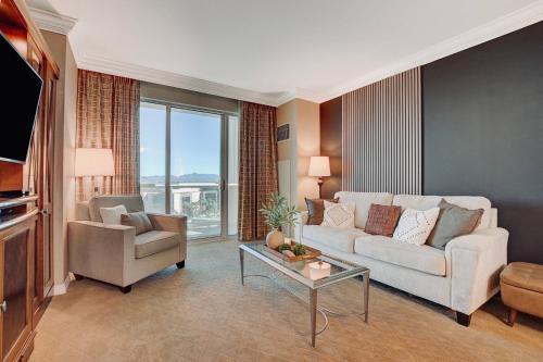 a living room with a couch and a table at LUXE 702 MGM Signature with Balcony in Las Vegas