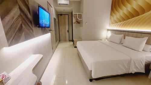 Postel nebo postele na pokoji v ubytování SIP Azana Hotel Jayapura