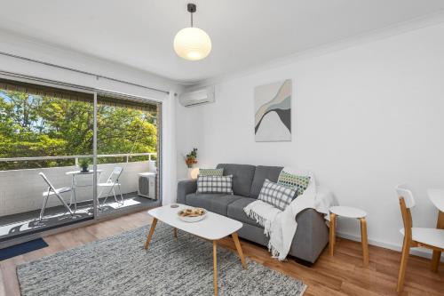 a living room with a couch and a table at 22 Superb Subiaco Apt For Couplesparkng in Perth