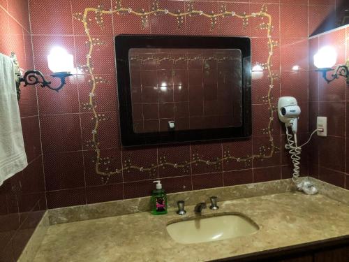a bathroom with a sink and a mirror at Micasa Hostel - Congonhas in Sao Paulo