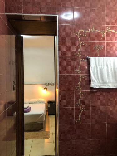 a bathroom with a toilet and a tub in a room at Micasa Hostel - Congonhas in Sao Paulo