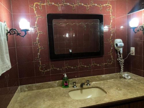 a bathroom with a sink and a mirror at Micasa Hostel - Congonhas in Sao Paulo