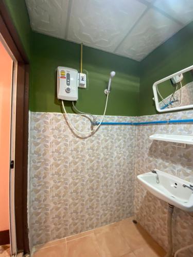 a bathroom with a shower and a sink at Bansuan Inthanon Eco Resort in Chom Thong