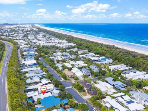 an aerial view of a beach with houses and the ocean at Casuarina Cove in Casuarina