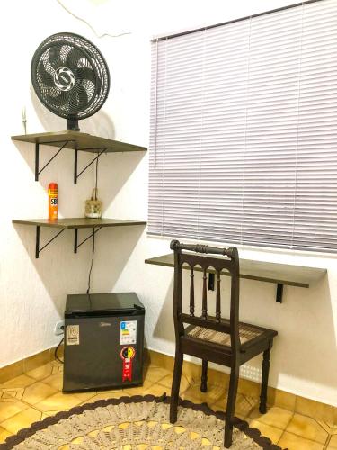 a chair sitting in a room with a window at Micasa Hostel - Congonhas in Sao Paulo