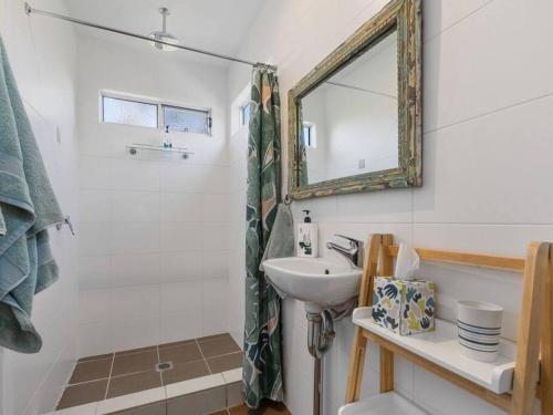 a bathroom with a sink and a mirror at Casuarina Cove in Casuarina