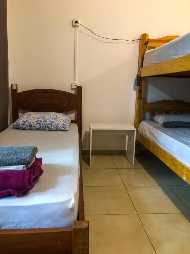 a room with two bunk beds and a table at Micasa Hostel - Congonhas in Sao Paulo