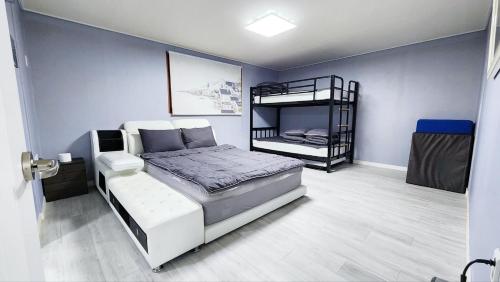 a bedroom with a bed and a bunk bed at The house of gallery in Daegu