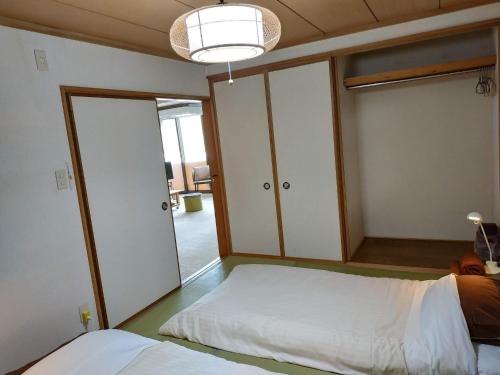 een slaapkamer met 2 kasten en een bed erin bij Bay View House private room / Vacation STAY 3667 in Otaru