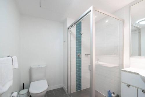 a bathroom with a shower and a toilet and a sink at Comfy 2B1B CBD Riverview apt w Parking+Pool+Gym in Brisbane