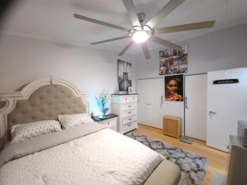a bedroom with a bed and a ceiling fan at Little Paris in Owings Mills