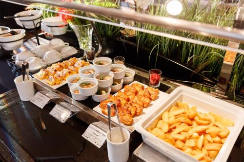 a buffet of food with french fries and dips at Kanazawa New Grand Hotel Prestige in Kanazawa