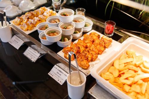 a buffet with different types of food and french fries at Kanazawa New Grand Hotel Prestige in Kanazawa