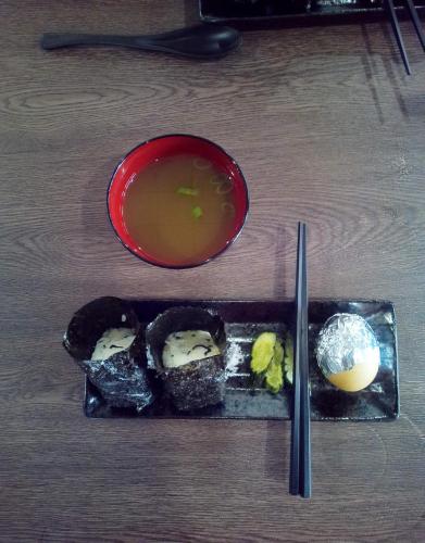 a plate of sushi and a bowl of soup at T&T Fujiyama Guest House in Fujiyoshida