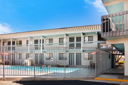 a building with a swimming pool in front of a building at Quality Inn Santa Fe New Mexico in Santa Fe