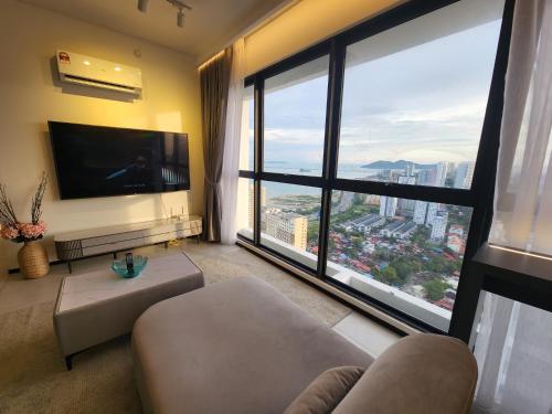 a living room with a large view of a city at Urban Suites - Penang in Jelutong