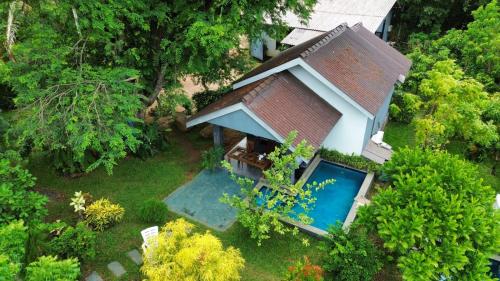an overhead view of a house with a swimming pool at Hidden Lake Cottages Sigiriya in Sigiriya