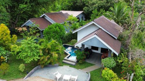 an aerial view of a house with a swimming pool at Hidden Lake Cottages Sigiriya in Sigiriya