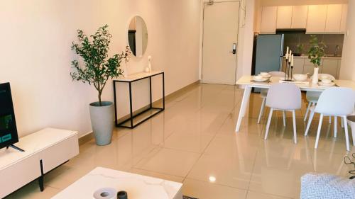 a large living room with a table and chairs at Kulai d putra suites beside ioiMall near JPO and Airport in Kulai
