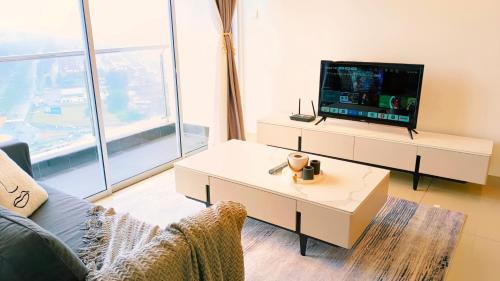 a living room with a tv and a couch at Kulai d putra suites beside ioiMall near JPO and Airport in Kulai