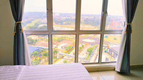 a bed in a room with a large window at Kulai d putra suites beside ioiMall near JPO and Airport in Kulai