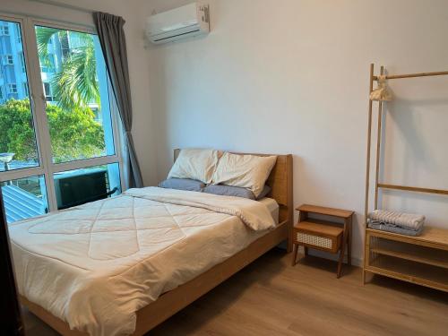 a bedroom with a bed and a large window at Muji Wi-Fi Aircond HomeStay in Sandakan