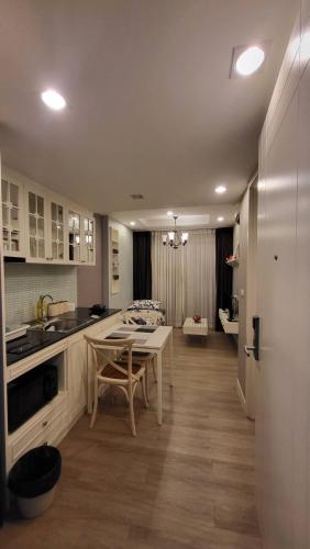 a kitchen with a table and a dining room at The Blu X Bangsaen F5 R51 in Ban Bang Saen (1)