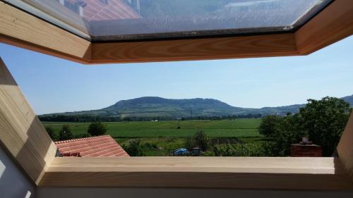 a window in a house with a view of a field at Penzion Dolní Dunajovice in Dolní Dunajovice