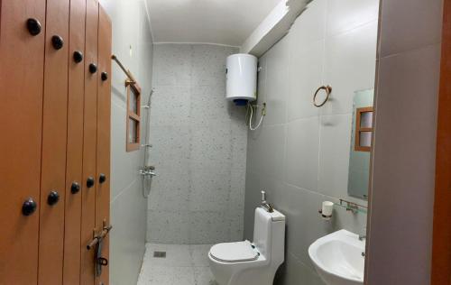 a small bathroom with a toilet and a sink at بيت نُزل السلام Bait Salam inn in Al Ḩamrāʼ