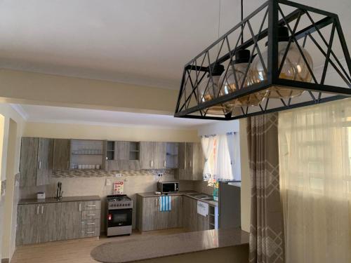 a kitchen with a black light hanging from the ceiling at 3 bedroom maisonette in Kitengela, Nairobi in Kitengela 