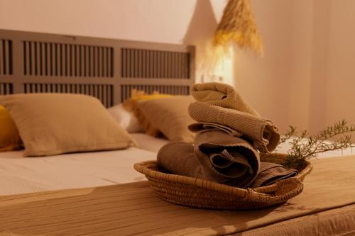 a basket of towels sitting on top of a bed at Townhouse Sa Casa in Sineu