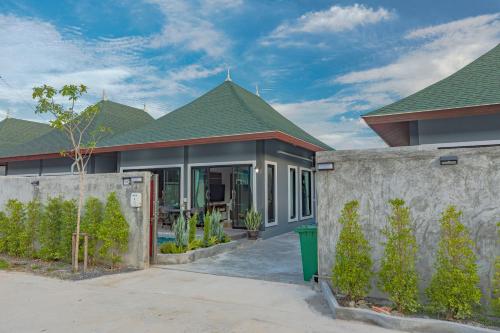 a house with a fence in front of it at N&D Poolvilla in Ao Nang Beach