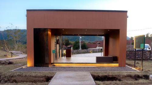 a building with an open door with a couch in it at Bobocabin Gunung Rinjani, Lombok in Sembalun Lawang