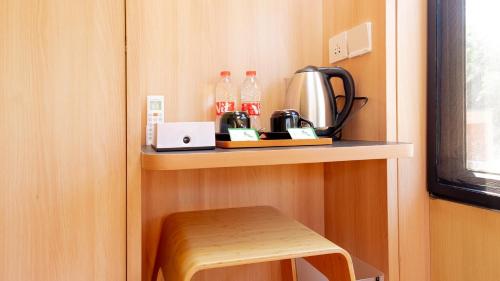 a shelf in a room with a coffee maker and a stool at Bobocabin Gunung Rinjani, Lombok in Sembalun Lawang