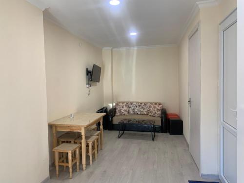 a small room with a table and a couch at Cozy apartment in Ureki in Ureki